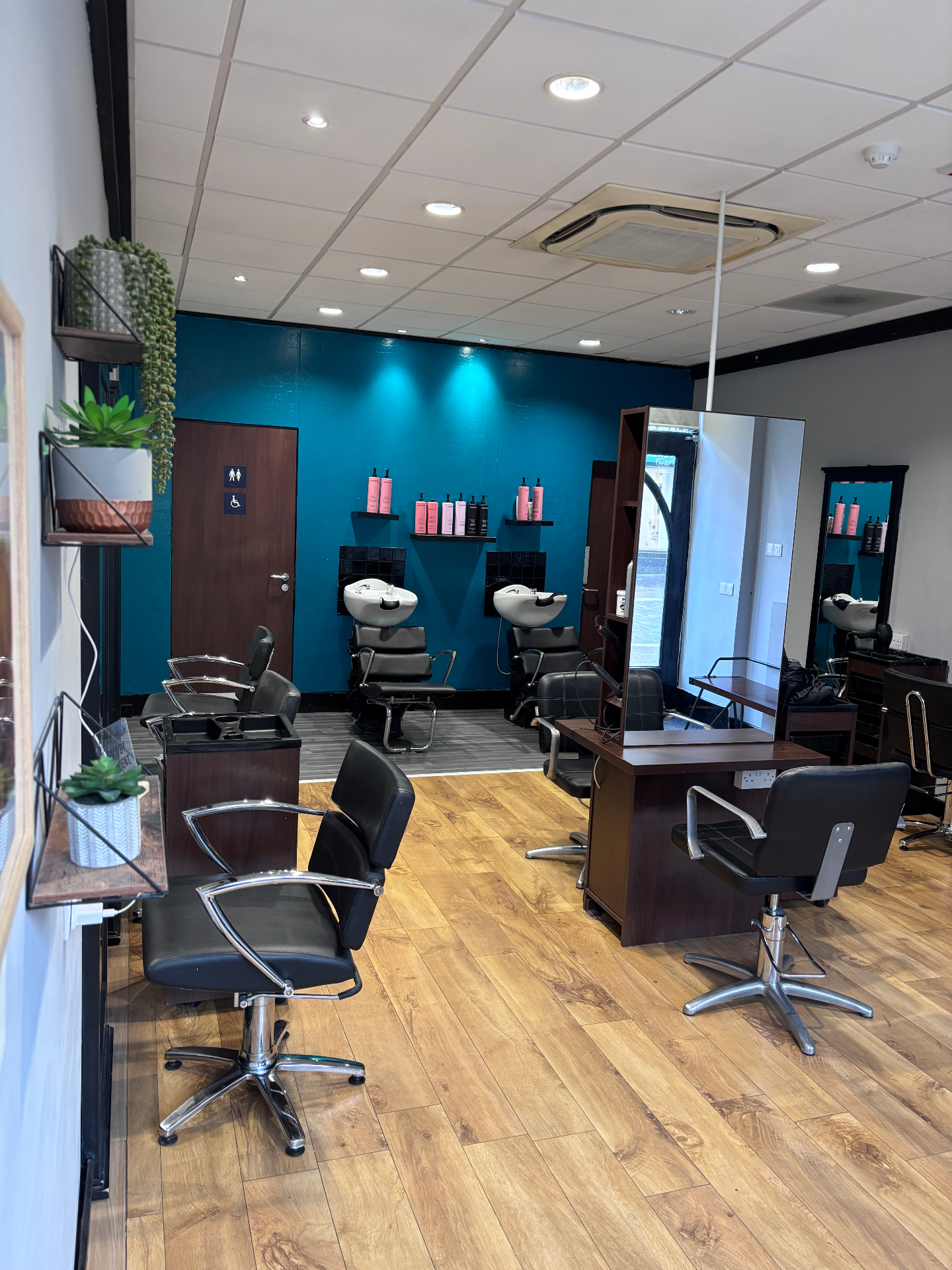 Wider view of the salon floor and wash basins